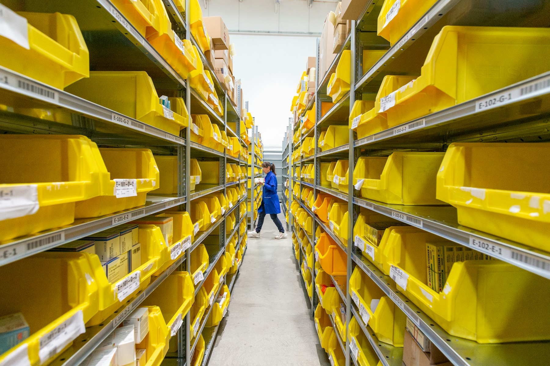 Warehouse shelves stocked with product bins