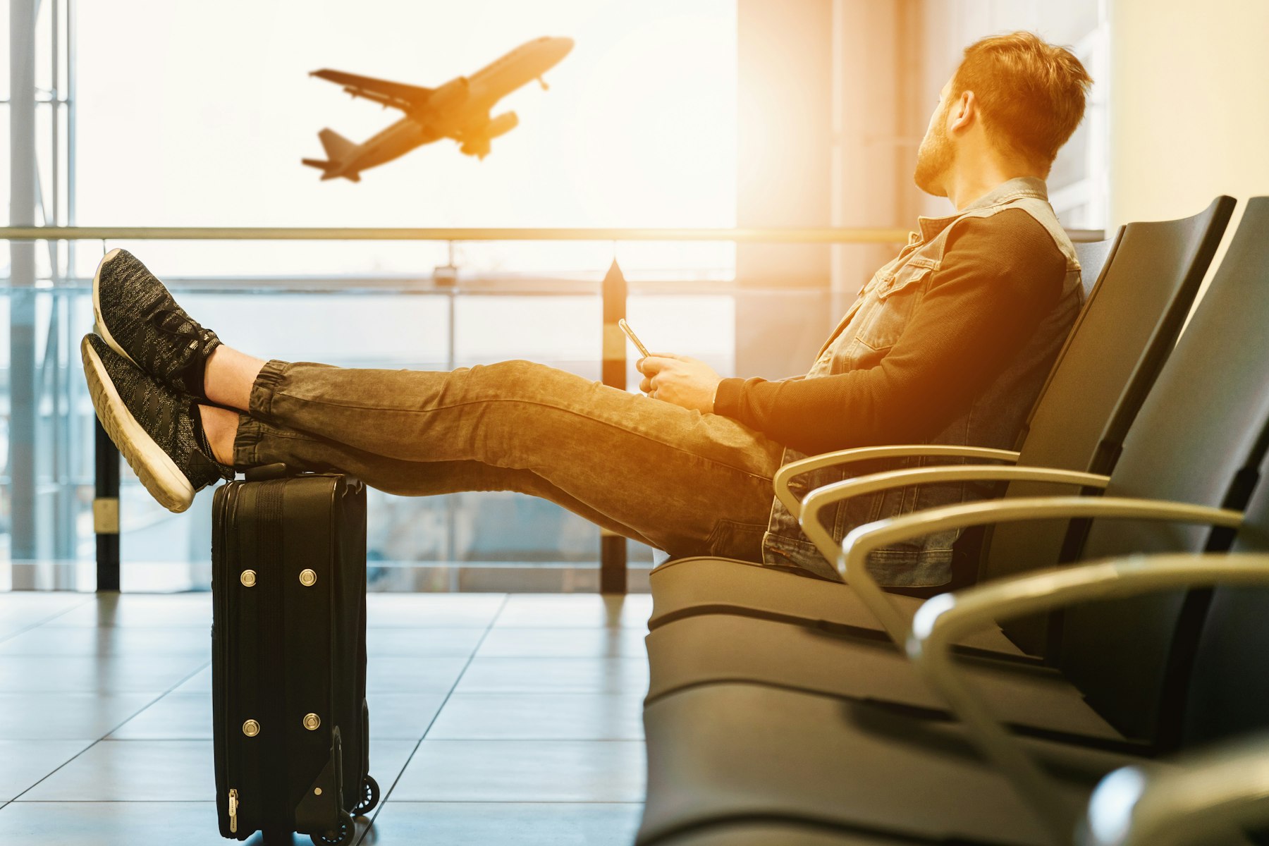 Business traveller waiting at an airport gate